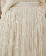 Load image into Gallery viewer, Designed for both elegance and ease, this pleated skirt features a stunning luminous, sheen finish and a comfortable elastic waistband, making it a go-to piece for various occasions. Made with durable polyester and lined with soft viscose, it offers a perfect combination of fashion and practicality. Pair it with heels for a night out or flats for a relaxed yet chic look.