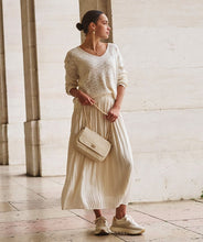 Load image into Gallery viewer, Designed for both elegance and ease, this pleated skirt features a stunning luminous, sheen finish and a comfortable elastic waistband, making it a go-to piece for various occasions. Made with durable polyester and lined with soft viscose, it offers a perfect combination of fashion and practicality. Pair it with heels for a night out or flats for a relaxed yet chic look.