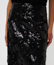 Load image into Gallery viewer, Close-up of black sequin skirt with floral cutouts.
