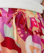 Load image into Gallery viewer, Asymmetric skirt with descending flounce in the beautiful print called "Heat Wave." Besides being super stylish, this skirt is also super comfortable due to the stretchy waistband. Style with your favorite white top and sandals for the perfect summer outfit.