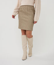 Load image into Gallery viewer, Model wearing a taupe skirt, beige sweater and knee-high cream boots against a white background.