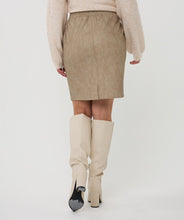 Load image into Gallery viewer, Model wearing a taupe skirt, beige sweater and knee-high cream boots against a white background.
