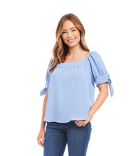 Load image into Gallery viewer, This lovely top features a trend-right square neckline and billowy sleeves detailed with darling ties. The perfect partner to all your denim, or any pair of black or white pants, this feminine style is the ultimate day-to-night piece. Color- Sky blue. Puff sleeve with ties. Square neck. Relaxed fit. Fabric-100% Polyester.