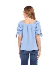 Load image into Gallery viewer, This lovely top features a trend-right square neckline and billowy sleeves detailed with darling ties. The perfect partner to all your denim, or any pair of black or white pants, this feminine style is the ultimate day-to-night piece. Color- Sky blue. Puff sleeve with ties. Square neck. Relaxed fit. Fabric-100% Polyester.