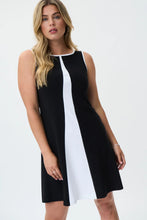 Load image into Gallery viewer, Make a statement with the Joseph Ribkoff Black and Vanilla Dress, designed for effortless elegance. This sleeveless, knee-length dress features a modern color-blocked design, perfect for both formal events and casual outings. Crafted from soft ITY fabric, it offers a comfortable stretch fit that moves with you. Designed for versatility, the Black/Vanilla color combination creates a striking contrast, making it perfect for both daytime chic and evening elegance.