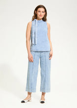 Load image into Gallery viewer, Timelessly chic, this powder wash blue sleeveless blouse features a flattering bow-tie neck, perfect for adding sophistication to any outfit. Whether you're dressing up for a day at the office or a night out, this elegant piece offers effortless style.