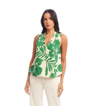 Load image into Gallery viewer, Woman wearing a sleeveless top with green and cream floral and leaf pattern on a white background.