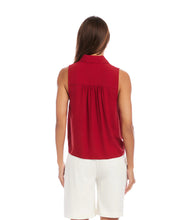 Load image into Gallery viewer, Woman wearing a red sleeveless top and white shorts on a white background.