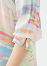 Load image into Gallery viewer, This stylish and comfortable shirt features a multicolor abstract print that adds a pop of color to any outfit. With its split V-neck design and darling three-quarter sleeves with ruffled cuffs, this shirt combines modern fashion with timeless elegance. Whether you're pairing it with jeans for a casual look or dress pants for a more polished ensemble, the Starla is a versatile addition to your collection.