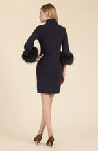 Load image into Gallery viewer, This season, elevate your special occasion wardrobe with the Sloane Fur Trimmed Knit Dress in Black by Tyler Boe. Enhanced with sophistication and glamour, this dress features a chic mock neck and luxurious fur cuffs. Make a statement and stand-out in a crowd with this stunning piece.