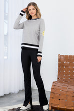 Load image into Gallery viewer, The Heather Gray Smiley Face Knit Sweater - TMK1517 from THML features classic black and white stripes on a gray background but adds a cheerful touch with a darling yellow smiley face on the upper part of each sleeve. This lightweight sweater has a vintage feel and modern appeal, with striping at the bottom hem, cuffs, and neck. Color- Gray, black, white and yellow. Smiley face on upper sleeves. Black and white striping on neckline, sleeves and bottom hem. Lightweight sweater.