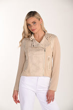 Load image into Gallery viewer, Woman wearing a beige jacket and white pants against a white background.