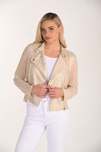 Load image into Gallery viewer, Woman wearing a beige leather jacket over a white top and pants on a white background.