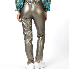 Load image into Gallery viewer, Our "Trousers Tregging PU" provides a combination of two different styles. Crafted from top-notch faux leather, these treggings offer a comfortable fit with a fashionable look. With its legging-style and a trouser design, this tregging has an unique presentation. Adding a subtle splash of gold helps to give it a modern, chic appearance. Color - Soft gold. Pull on. Faux leather. Elastic waistband. Functional front and back pockets.