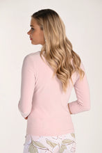 Load image into Gallery viewer, Woman wearing a light pink three quarter sleeve top and floral pants on a white background.