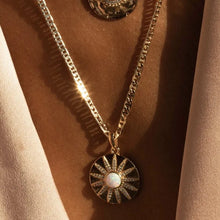 Load image into Gallery viewer, A brilliant necklace made for a goddess. The Stargazer Necklace features a shimmering gold sunburst pendant with a fiery opal center surrounded by sparkling CZs. This piece was made to reflect the light and be seen! Colors- Gold, white and clear. Opal Stone with Cubic Zirconia. 14K gold plate over brass. 20mm charm diameter. 18" chain + 2" extender.
