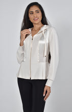 Load image into Gallery viewer, Crafted by the renowned Frank Lyman designer, this stylish jacket exudes sophistication and elegance, making it a versatile addition to any wardrobe. The stunning stone color is complemented by contrasting fabrics, featuring a sleek knit with satin panels. Adding an edgy touch, the hooded design is enhanced by gold zipper detailing for a brilliant contrast. Color- Stone. Hooded. Gold zipper closure.
