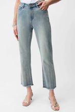 Load image into Gallery viewer, Model wearing light blue crop jeans with sequins and silver heels on a white background.