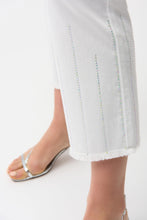 Load image into Gallery viewer, Close-up of white pants with decorative stitching on a white background.
