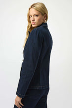 Load image into Gallery viewer, Woman wearing an indigo blue denim jacket and jeans against a white background.