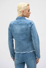 Load image into Gallery viewer, The Joseph Ribkoff Sybella Stretch Denim Jacket is a perfect fusion of classic and modern design. Made from eco-friendly Repreve® stretch denim, this piece features intricate eye-catching embroidery and sparkling rhinestones for a unique touch. With a traditional shirt collar, button closure, and functional chest pockets, it blends style and practicality. The medium blue wash makes it a versatile addition to any wardrobe, ideal for layering with both casual and dressy outfits.
