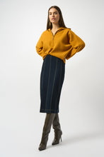 Load image into Gallery viewer, Woman wearing a mustard yellow sweater and indigo blue pencil denim skirt and tall brown boots against a white background.