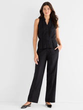 Load image into Gallery viewer, Woman wearing a black sleeveless top, black pants and black flats against a white background.