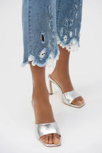 Load image into Gallery viewer, The Joseph Ribkoff Stretch Straight Crop Jeans are a perfect blend of comfort and elegance. Made from eco-friendly Repreve® stretch denim, these jeans feature intricate embroidery, delicate lace inserts, and sparkling iron-on stones for a unique, feminine flair. The frayed hem and classic 5-pocket design add a playful yet timeless appeal. With a flattering straight-crop silhouette, these jeans are versatile enough for both casual outings and chic evening looks.