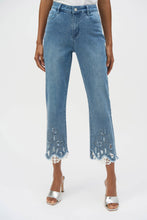 Load image into Gallery viewer, The Joseph Ribkoff Stretch Straight Crop Jeans are a perfect blend of comfort and elegance. Made from eco-friendly Repreve® stretch denim, these jeans feature intricate embroidery, delicate lace inserts, and sparkling iron-on stones for a unique, feminine flair. The frayed hem and classic 5-pocket design add a playful yet timeless appeal. With a flattering straight-crop silhouette, these jeans are versatile enough for both casual outings and chic evening looks.