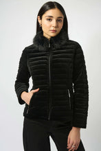 Load image into Gallery viewer, Woman modeling a black quilted jacket with fur collar and black pants against a white background.