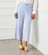 Load image into Gallery viewer, The Stripe Cropped Pants by Karen Kane offer a contemporary and polished aesthetic, perfect for effortless styling. Designed with wide legs and a cropped length, these pants feature striking blue and cream stripes for a bold yet sophisticated look. The high-rise waist provides a flattering fit, while the contrast stripe pockets add a stylish touch.