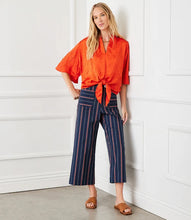 Load image into Gallery viewer, Designed with a contemporary and professional aesthetic, these navy wide-leg pants boast a cropped cut and striking orange pinstripes. The ideal pop of color to add to your wardrobe, these versatile pants seamlessly transition from the office to chic evening out.