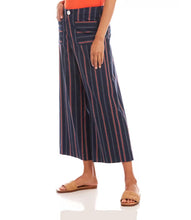 Load image into Gallery viewer, Designed with a contemporary and professional aesthetic, these navy wide-leg pants boast a cropped cut and striking orange pinstripes. The ideal pop of color to add to your wardrobe, these versatile pants seamlessly transition from the office to chic evening out.