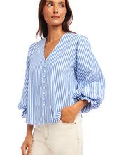 Load image into Gallery viewer, Woman wearing a blue and white striped blouse against a white background.