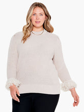 Load image into Gallery viewer, Bring a twist to your classic sweater with this statement-making fringe detail. The body has been knitted with a shaker stitch for a soft and comfortable feel. The pleats at the shoulder result in an effortless, feminine shape. This stunning style falls at the hips with ease. Color- Canva. Pullover sweater. Pleated sleeve with fringe cuff. Midweight. Regular fit. Crewneck. Bracelet sleeve.