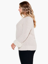 Load image into Gallery viewer, Bring a twist to your classic sweater with this statement-making fringe detail. The body has been knitted with a shaker stitch for a soft and comfortable feel. The pleats at the shoulder result in an effortless, feminine shape. This stunning style falls at the hips with ease. Color- Canva. Pullover sweater. Pleated sleeve with fringe cuff. Midweight. Regular fit. Crewneck. Bracelet sleeve.