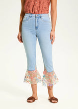 Load image into Gallery viewer, A perfect blend of classic charm and modern flair, these cropped flare jeans feature a contrasting floral fabric hem, adding a unique touch to a timeless silhouette. Designed for comfort and style, they offer a high-rise fit that flatters all body types.
