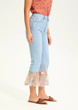 Load image into Gallery viewer, A perfect blend of classic charm and modern flair, these cropped flare jeans feature a contrasting floral fabric hem, adding a unique touch to a timeless silhouette. Designed for comfort and style, they offer a high-rise fit that flatters all body types.