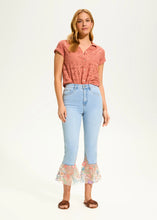 Load image into Gallery viewer, A perfect blend of classic charm and modern flair, these cropped flare jeans feature a contrasting floral fabric hem, adding a unique touch to a timeless silhouette. Designed for comfort and style, they offer a high-rise fit that flatters all body types.