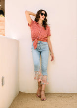 Load image into Gallery viewer, A perfect blend of classic charm and modern flair, these cropped flare jeans feature a contrasting floral fabric hem, adding a unique touch to a timeless silhouette. Designed for comfort and style, they offer a high-rise fit that flatters all body types.