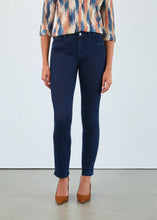 Load image into Gallery viewer, Model wearing dark blue jeans, a patterned top and brown heels against a white background.