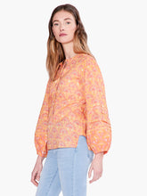 Load image into Gallery viewer, This bright and festive shirt takes your next casual look in an all-new direction. Tie the front to make a keyhole opening or leave it open. The design includes bracelet cuffs and flowy bishop sleeves. Sits just below the waist in an easy fitting silhouette. Color-Orange multi. Easy fit. Round neck. Bracelet sleeve. Bishop sleeve.
