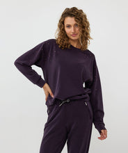 Load image into Gallery viewer, The EsQualo Embellished Sweatshirt is a stylish and comfortable piece. You won't believe the softness of this modal fabrication. It features a luxuriously soft feel and a classic round neck, making it perfect for cozy and stylish days. This sweatshirt has long sleeves and is embellished with shiny stones, adding a touch of elegance to your wardrobe.