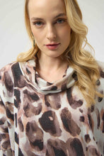 Load image into Gallery viewer, Woman wearing an off-white and brown multi animal print tunic sweater against a white background.