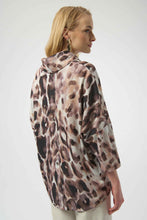 Load image into Gallery viewer, Woman wearing an off-white and brown multi animal print tunic sweater and off-white pants against a white background.