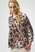 Load image into Gallery viewer, Woman wearing an off-white and brown multi animal print tunic sweater and off-white pants against a white background.