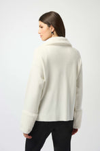 Load image into Gallery viewer, Woman wearing a Winter white zip-up coat with a fur-lined collar and cuffs and black pants against a white background.