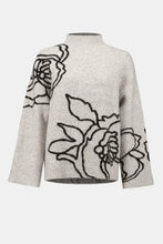 Load image into Gallery viewer, Boxy sweater in light grey with a black floral design against a white background.
