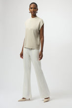 Load image into Gallery viewer, Woman wearing a light warm beige sparkling sleeveless top, white pants and light beige heels against a white background.