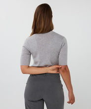 Load image into Gallery viewer, Model wearing a grey short sleeve top and grey pants against a plain background.